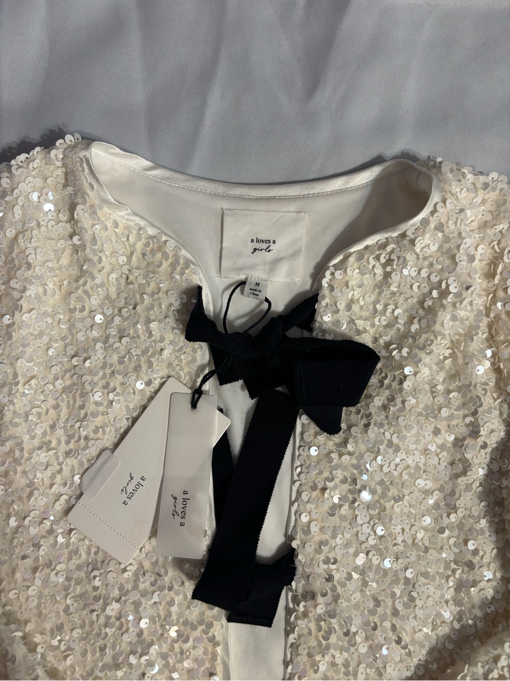 A Loves A Girl Ivory Sequin Jacket with Black Bow